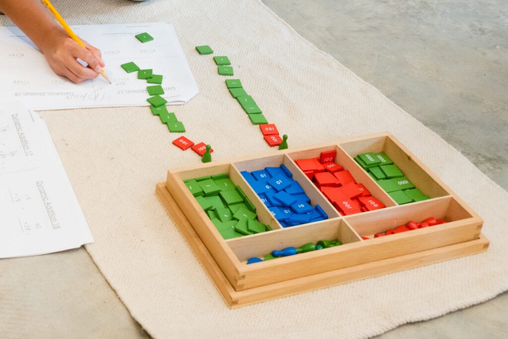 Colorful tiles of a Montessori math lesson, the stamp game for elementary students.
